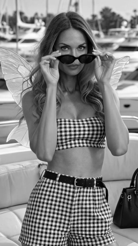 Mandi in black and white gingham with sunglasses and champagne on a yacht, a film by The Listing Fairies